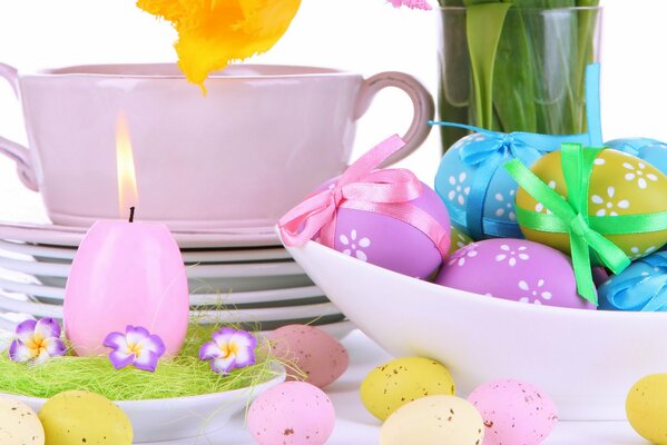 Easter eggs in a plate and a burning candle