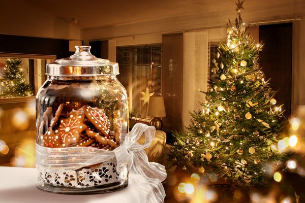 Cozy jar with cookies on the background of a Christmas tree