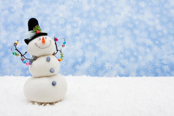 A cheerful snowman on the background of a blue sky with snowflakes