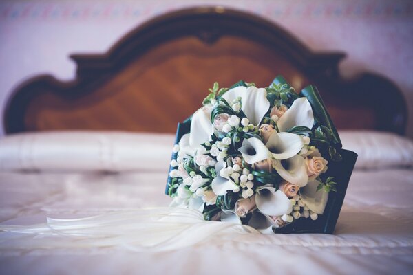 Wedding bouquet on the bed