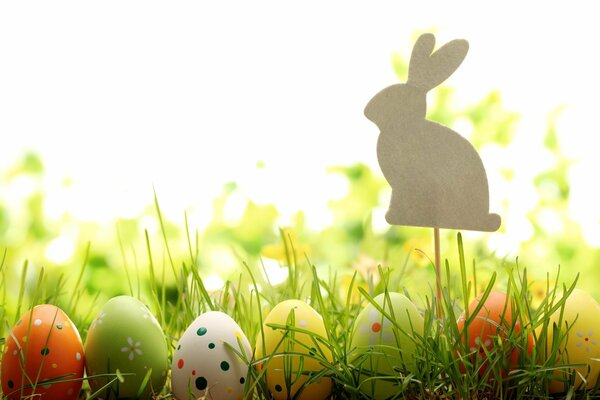 Easter eggs on the grass with a rabbit figurine