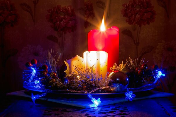 Christmas candles and decorations on a plate