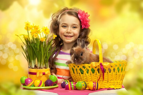 Fille avec des fleurs, des oeufs de Pâques et avec un lapin