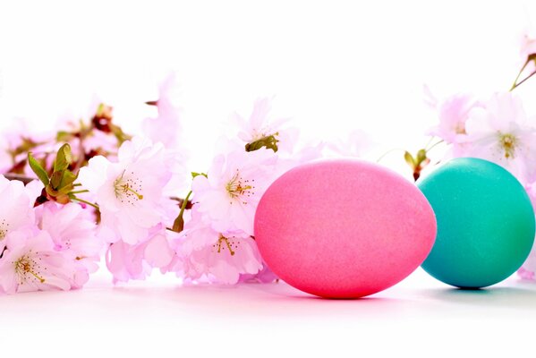 Painted eggs and pink flowers on a branch