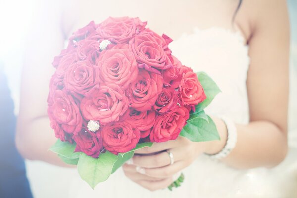 Wedding bouquet in the hands of the bride