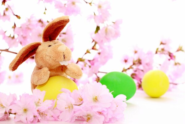 Easter bunny with eggs in flowers