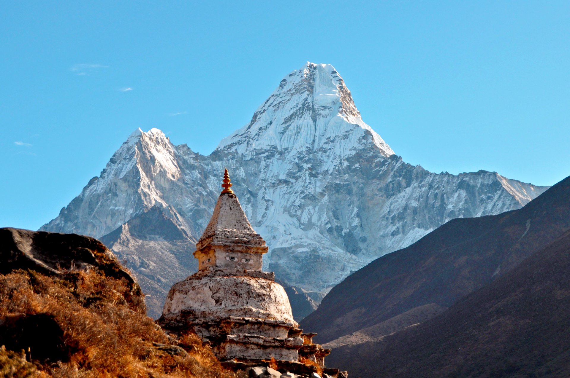 temple stone building drawn eyes blue sky lightweight cloud landscape mountain peak ama dablam ama dablam himalayas federal democratic republic nepal sanghiya loktāntrik ganatantra rock next white snow slopes land