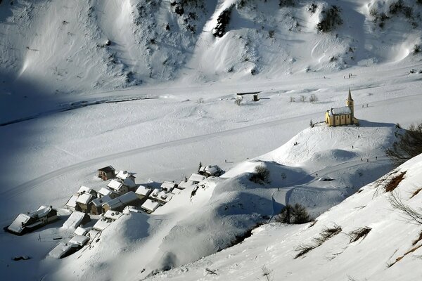 Winter landscape in a mountain village with a small temple