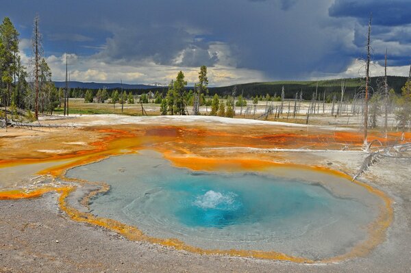 Clouds over a lake with a geyser