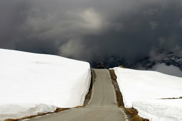 Hilly road in Norway among snowy fields