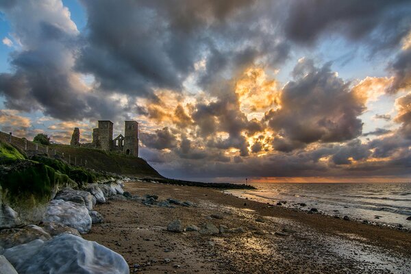 English sky with clouds . Ruins on the slope