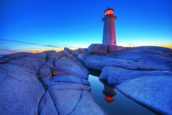 Faro en la roca agua Reflexión faro piedras