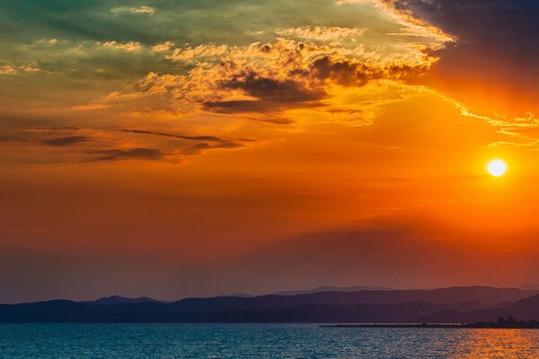 The surface of the water with a sunset sky