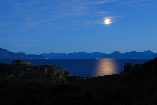 Cielo nocturno Luna entre las montañas