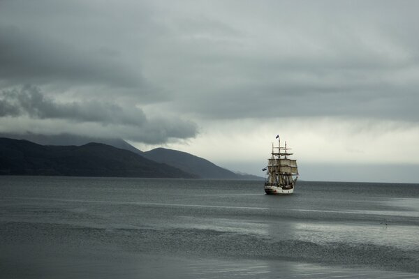 A ship sailing ashore in cloudy weather