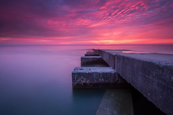 Calm sea with crimson sky