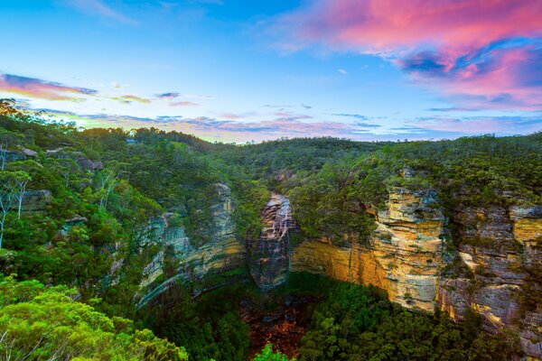 Cliffs with a waterfall and extensive forest