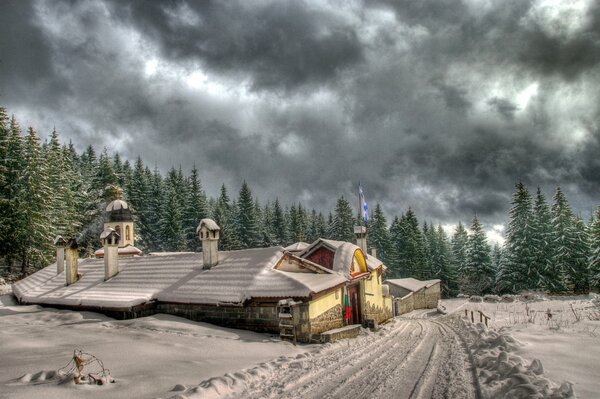 Snow clouds over the houses green Christmas trees snow drifts