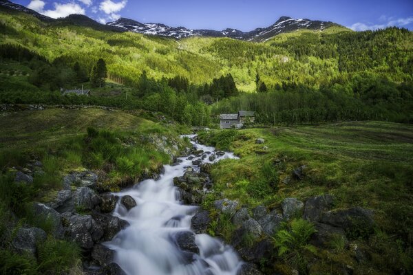 A mountain stream runs past the hut