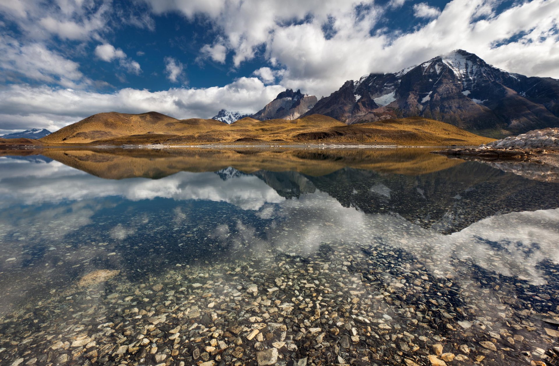 mountain tops snow lake reflection the bottom stones beach