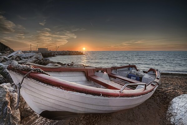 Boat on the shore at sunset