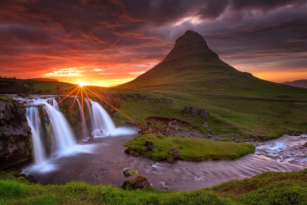 Waterfall and volcano in Iceland with sunset