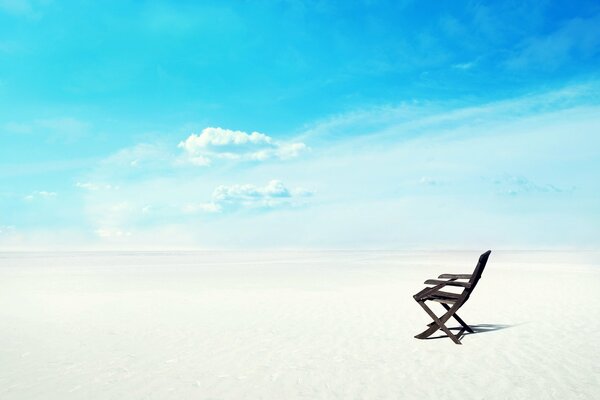 Wooden chair on the desert sand