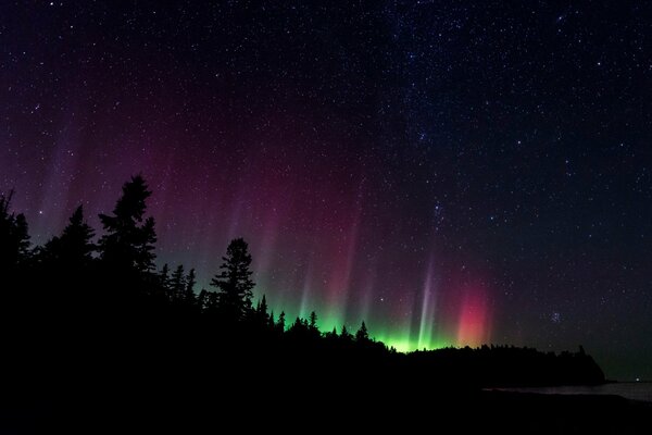 Northern lights in the night sky with stars