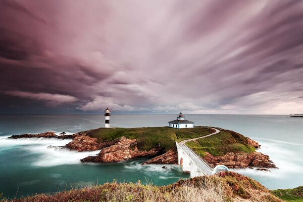 Lighthouse on the rocks of Spain illuminating the way