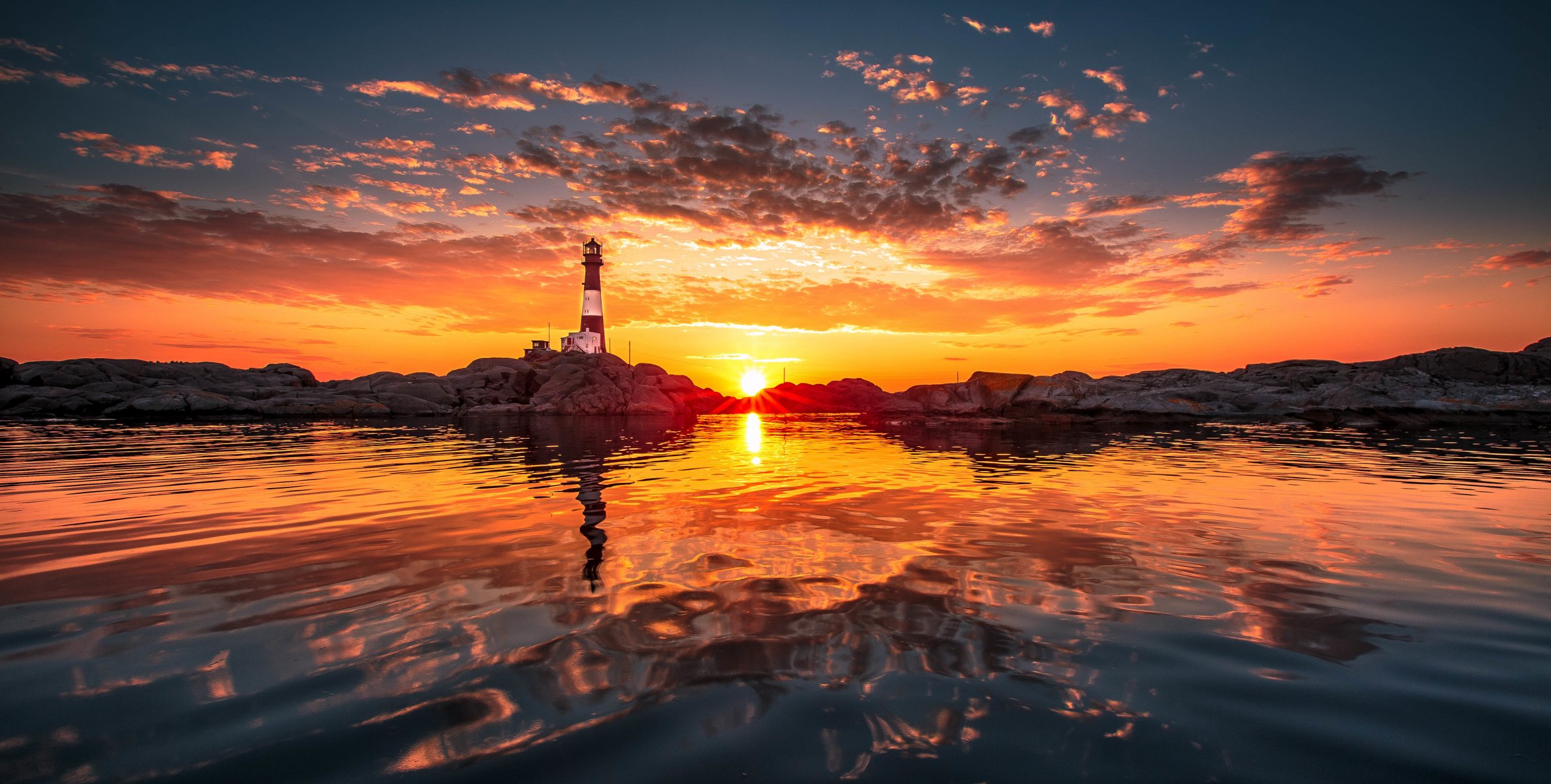 beach lighthouse sun clouds reflection