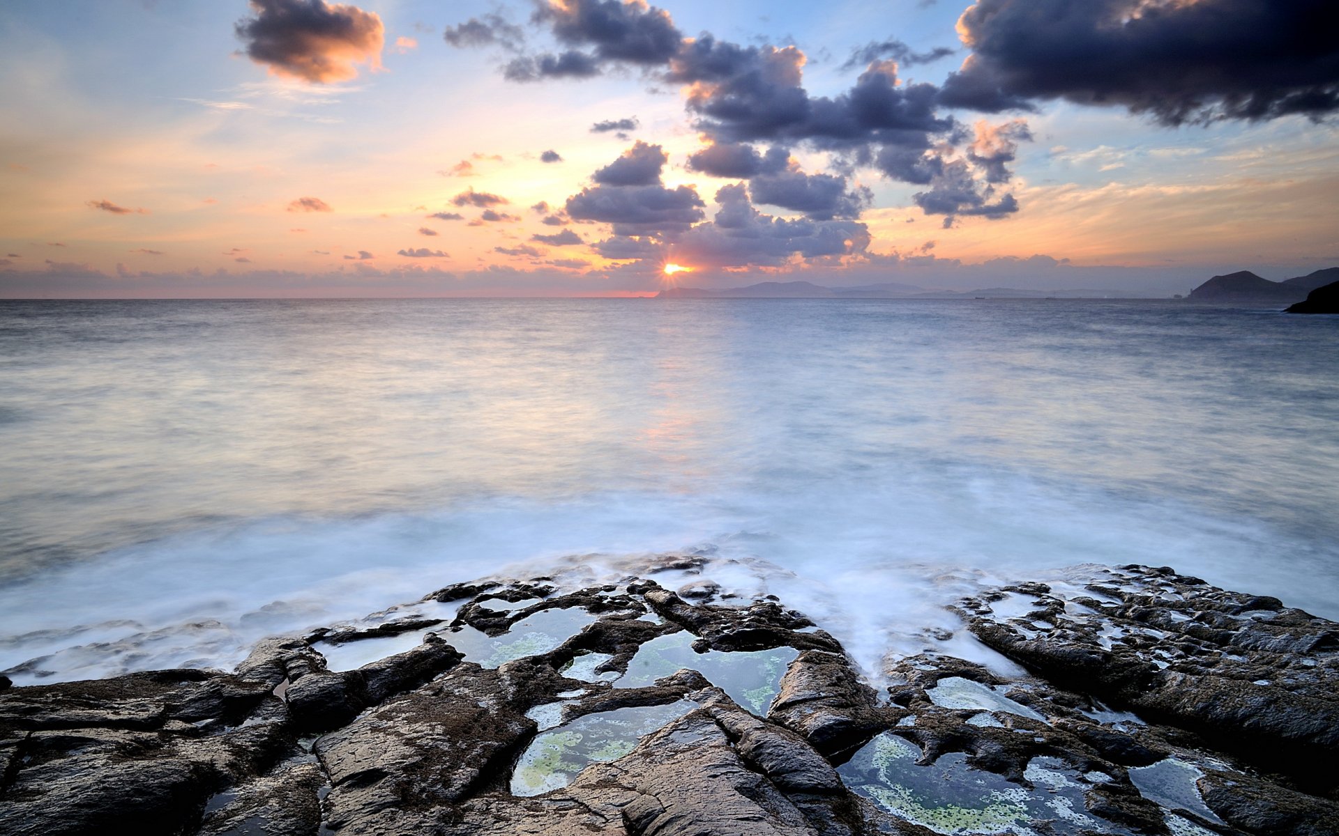 unset sea stones landscape