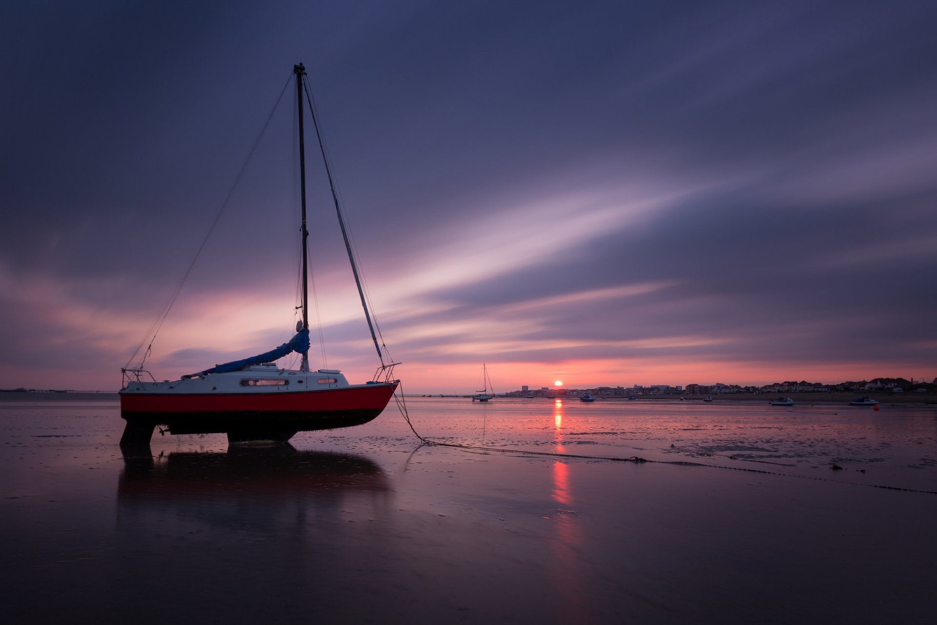 boat sea beach night sunset sun sky clouds horizon