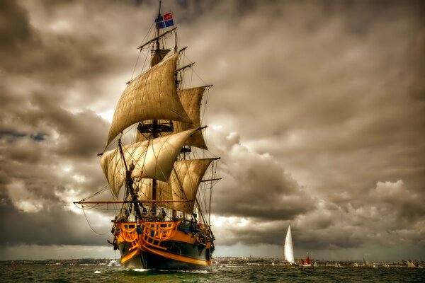 Sur le fond des nuages d orage, le navire flotte