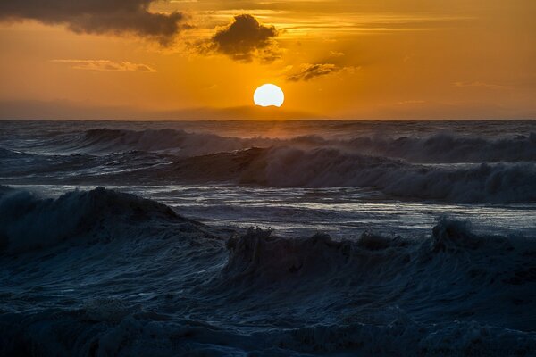 The riotous ocean in a scarlet sunset