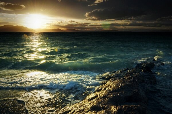 Seashore with bright sun and clouds