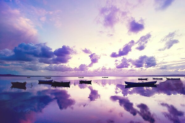 Boats in the sunset sea