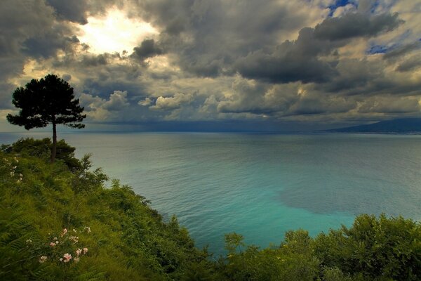 Turquoise Bay of Naples on the background of clouds
