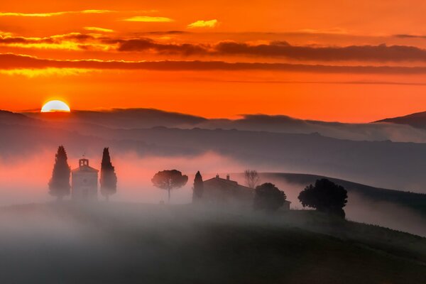 The beauty of the morning sunset and the city shining through the fog