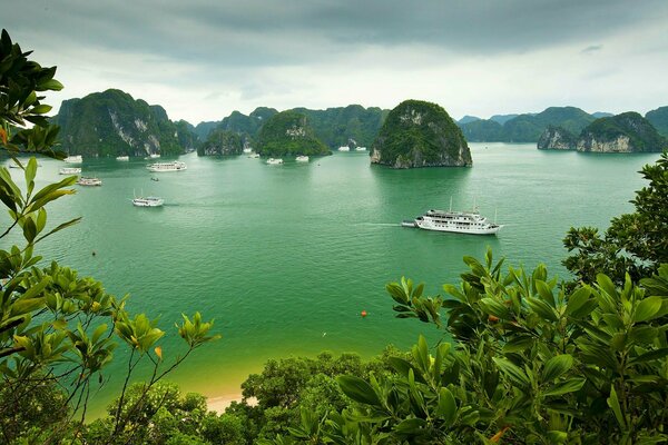 Vietnamese green bay and yachts in the distance