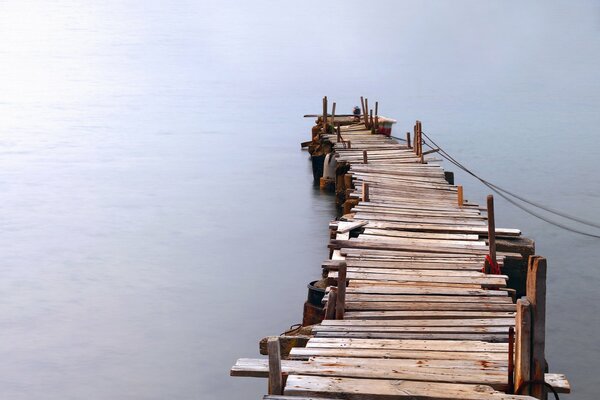 Wooden pier on the water. Deep Sea