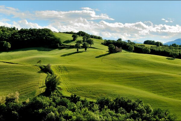 Clouds floating over green hills