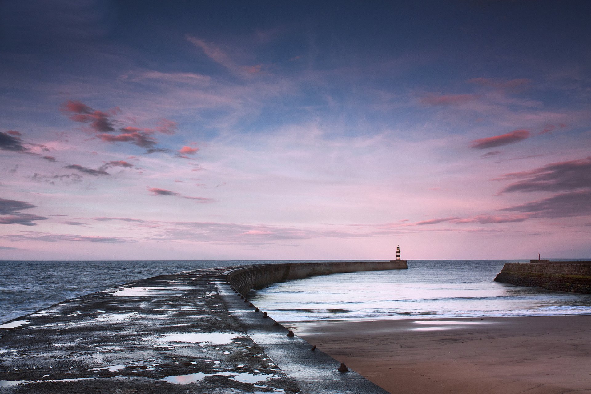 mar muelle faro puesta de sol