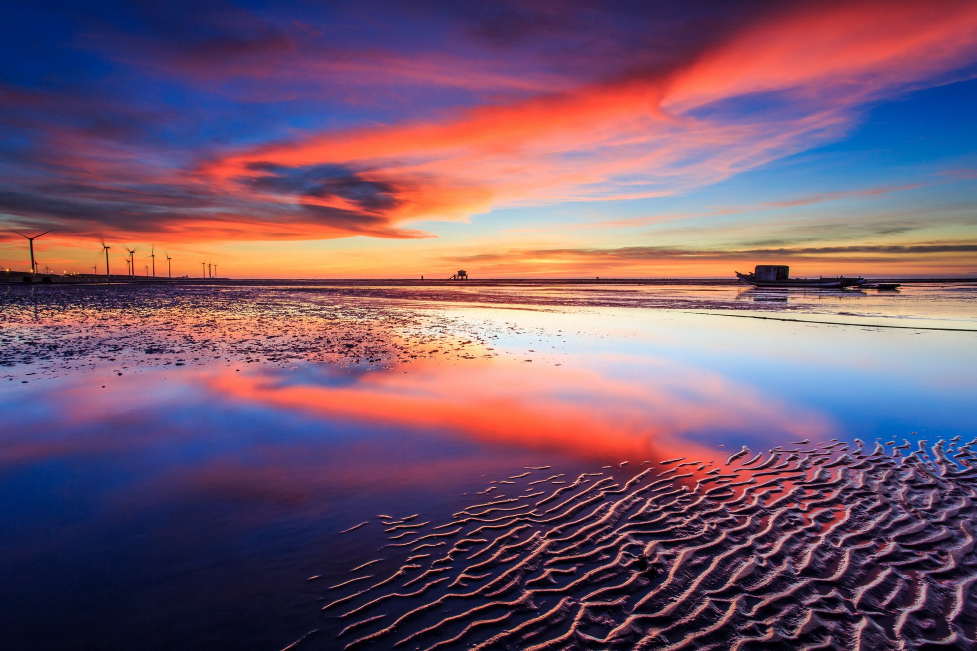 unset sea wind turbines landscape