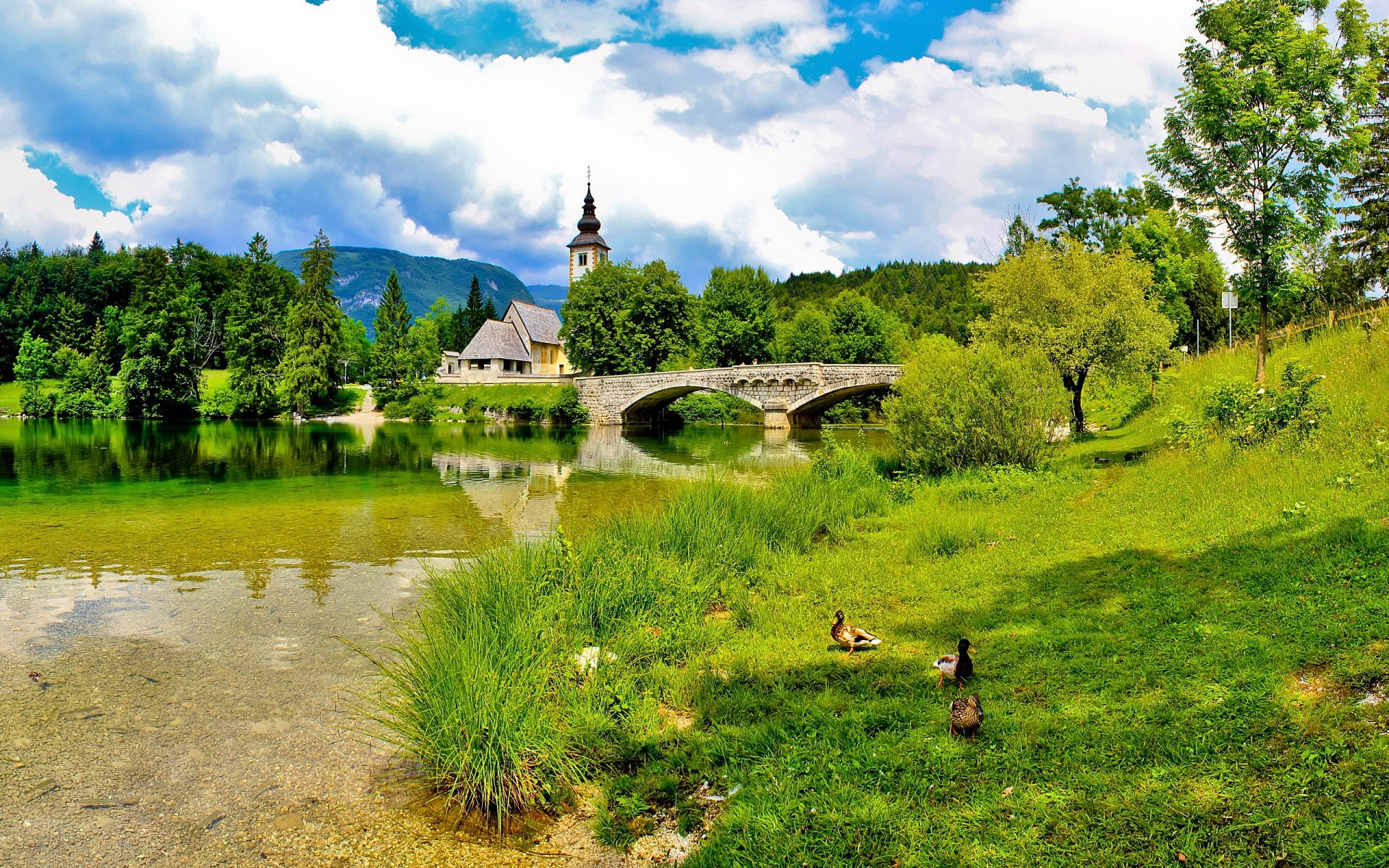 lovenia bridge church grass sky sun summer cloud