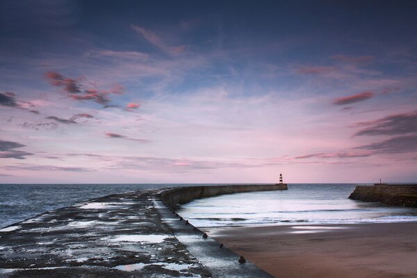 Mar muelle faro puesta de sol