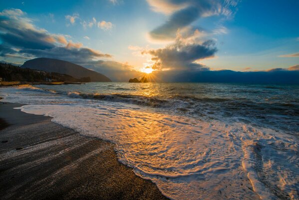 Crimea. Sea surf at sunset