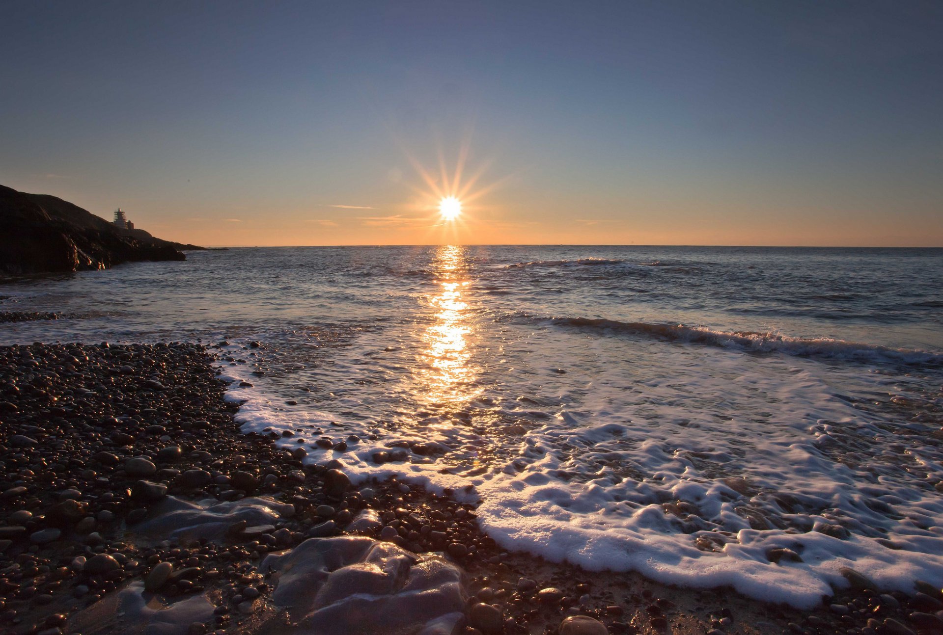 ea waves foam beach stones pebbles sun dawn