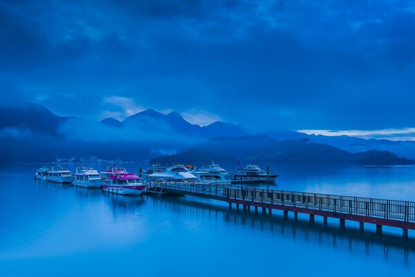 Jetty with boats and blue sky