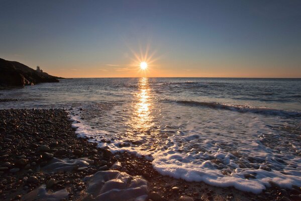 Sea foam with the setting sun