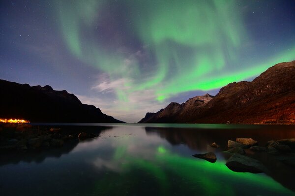 The Northern lights are reflected in the lake